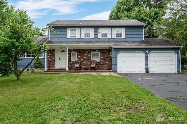 18 Chipper Dr, South Brunswick, NJ 08824 - view of front of home featuring asphalt driveway, covered porch, a front yard, and a garage