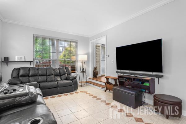 54 Magellan Way, Franklin Twsp, NJ 08823 - living room with tile patterned flooring, ornamental molding, and baseboards