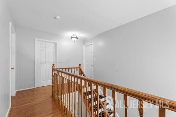 54 Magellan Way, Franklin Twsp, NJ 08823 - hallway featuring an upstairs landing, wood finished floors, and baseboards