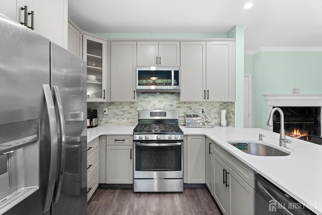 54 Magellan Way, Franklin Twsp, NJ 08823 - kitchen featuring appliances with stainless steel finishes, a sink, light countertops, decorative backsplash, and crown molding