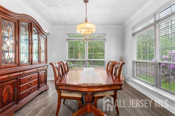 54 Magellan Way, Franklin Twsp, NJ 08823 - dining space featuring wood finished floors, a chandelier, baseboards, and crown molding