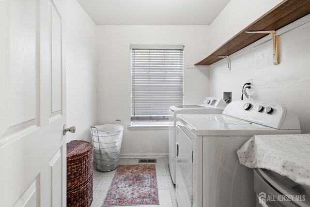 54 Magellan Way, Franklin Twsp, NJ 08823 - clothes washing area featuring separate washer and dryer, plenty of natural light, light tile patterned flooring, and baseboards