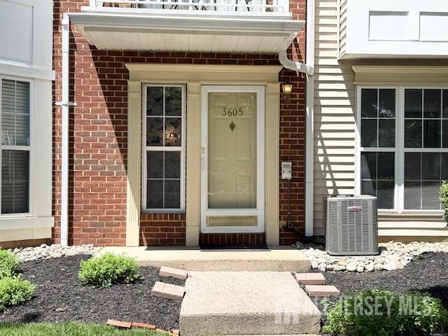 3605 Riddle Ct, Bridgewater, NJ 08807 - view of exterior entry with brick siding and a porch