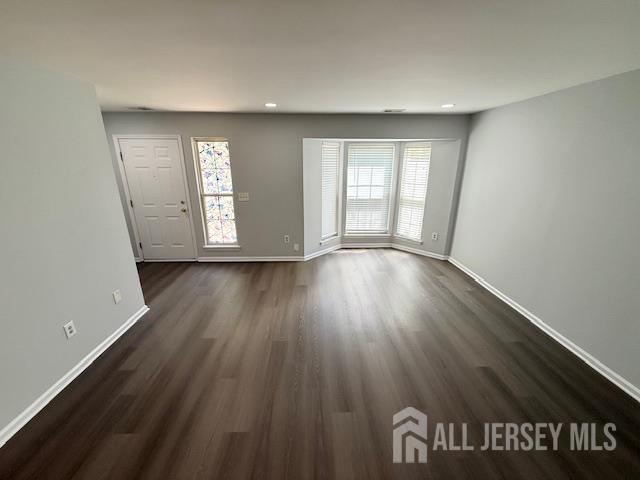3605 Riddle Ct, Bridgewater, NJ 08807 - unfurnished living room with healthy amount of natural light, dark wood-type flooring, and recessed lighting