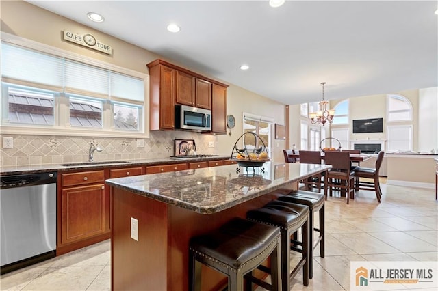 8 Adam Ct, Monroe, NJ 08831 - kitchen with stainless steel appliances, brown cabinets, decorative backsplash, a sink, and a chandelier