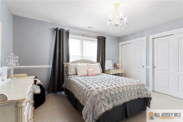 8 Adam Ct, Monroe, NJ 08831 - bedroom featuring light colored carpet, a chandelier, and two closets