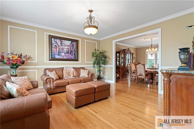 8 Adam Ct, Monroe, NJ 08831 - living area featuring light wood-type flooring, a chandelier, and ornamental molding