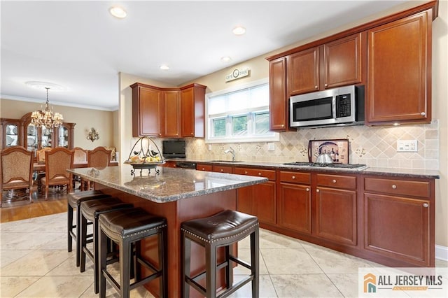 8 Adam Ct, Monroe, NJ 08831 - kitchen with stainless steel appliances, a sink, a kitchen breakfast bar, dark stone counters, and backsplash