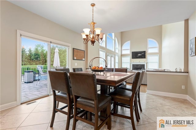 8 Adam Ct, Monroe, NJ 08831 - dining room featuring a chandelier, plenty of natural light, a fireplace, and light tile patterned flooring