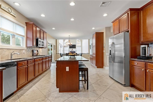 8 Adam Ct, Monroe, NJ 08831 - kitchen featuring appliances with stainless steel finishes, a sink, a chandelier, a kitchen bar, and a center island