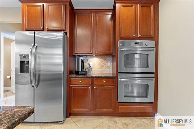 8 Adam Ct, Monroe, NJ 08831 - kitchen featuring stainless steel appliances, dark stone countertops, decorative backsplash, and brown cabinetry