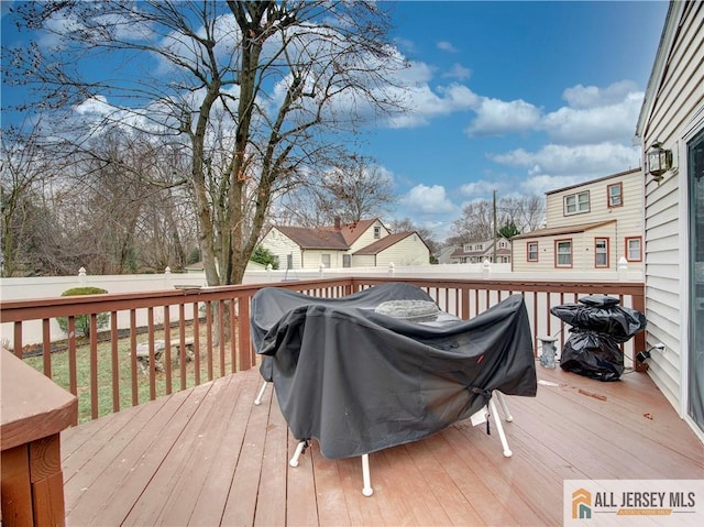 deck featuring a residential view, a fenced backyard, and area for grilling