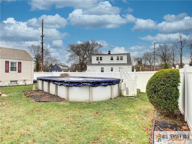 view of yard with a fenced in pool and a fenced backyard