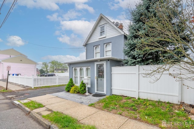 11 Mary Ave, Fords, NJ 08863 - victorian house with stucco siding, fence, and a chimney