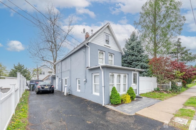 11 Mary Ave, Fords, NJ 08863 - view of side of property with stucco siding, a chimney, and fence