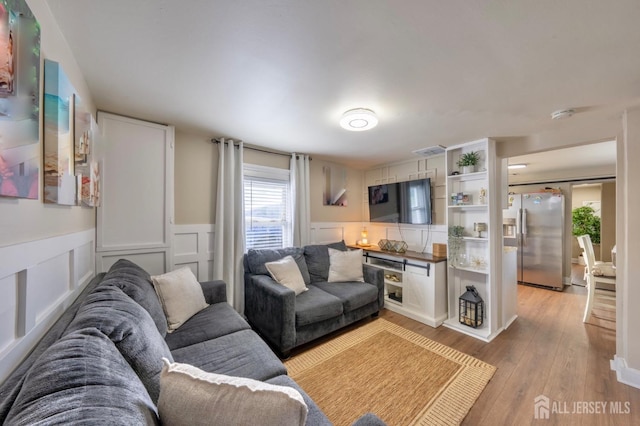 11 Mary Ave, Fords, NJ 08863 - living area featuring light wood-style flooring, a wainscoted wall, and a decorative wall