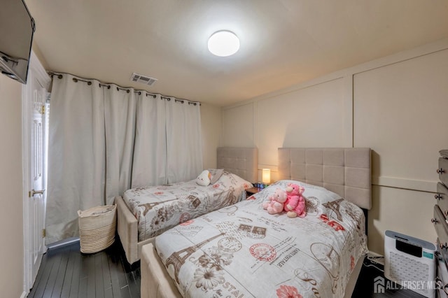 bedroom featuring visible vents and hardwood / wood-style floors