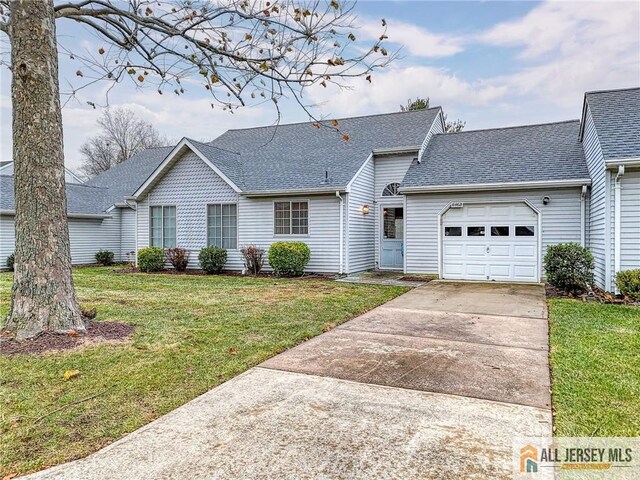 ranch-style home featuring a front yard and a garage