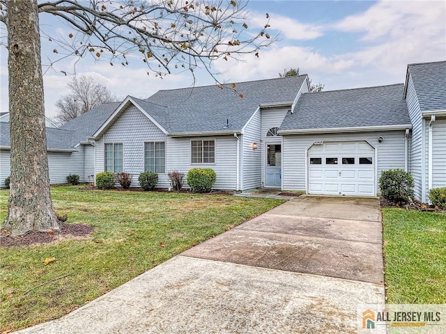 ranch-style home featuring a front lawn and a garage