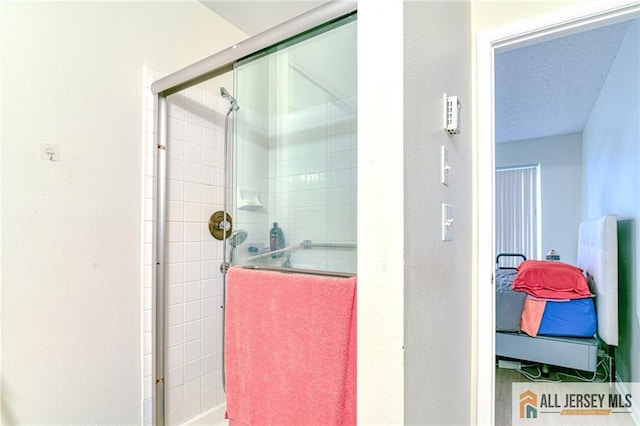 bathroom featuring a textured ceiling and walk in shower