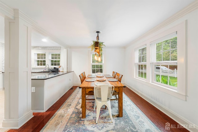 328 John St, Bound Brook, NJ 08805 - dining space featuring dark wood finished floors, healthy amount of natural light, and ornamental molding