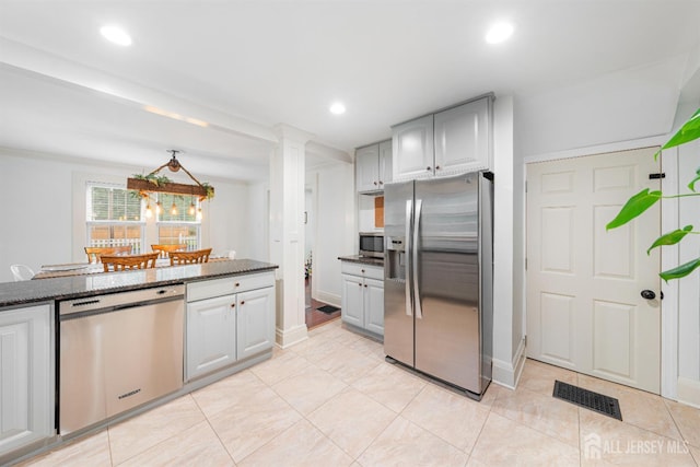 328 John St, Bound Brook, NJ 08805 - kitchen featuring stainless steel appliances, light tile patterned flooring, dark stone counters, ornate columns, and recessed lighting