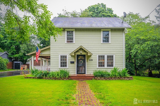 328 John St, Bound Brook, NJ 08805 - colonial inspired home featuring a front yard and covered porch