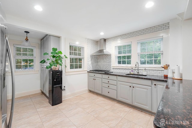 328 John St, Bound Brook, NJ 08805 - kitchen featuring wall chimney exhaust hood, backsplash, dark stone countertops, pendant lighting, and light tile patterned flooring