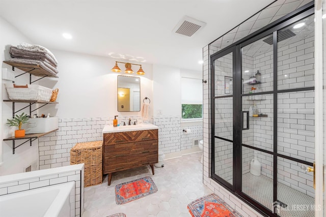 328 John St, Bound Brook, NJ 08805 - full bathroom with tile walls, vanity, a shower stall, a garden tub, and a wainscoted wall