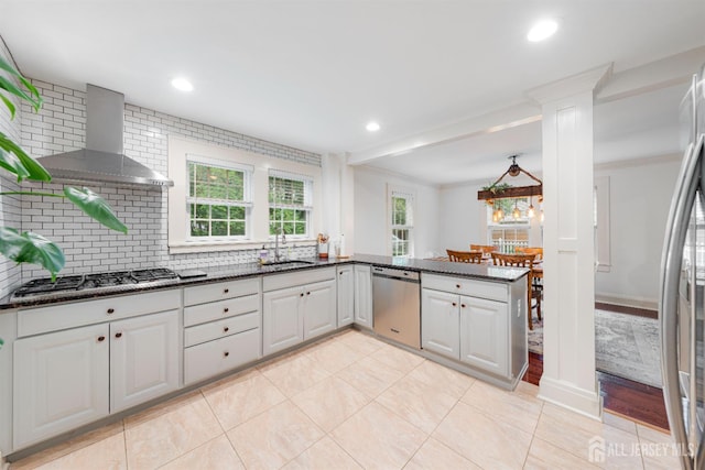 328 John St, Bound Brook, NJ 08805 - kitchen featuring stainless steel appliances, wall chimney exhaust hood, decorative backsplash, dark stone countertops, and ornamental molding