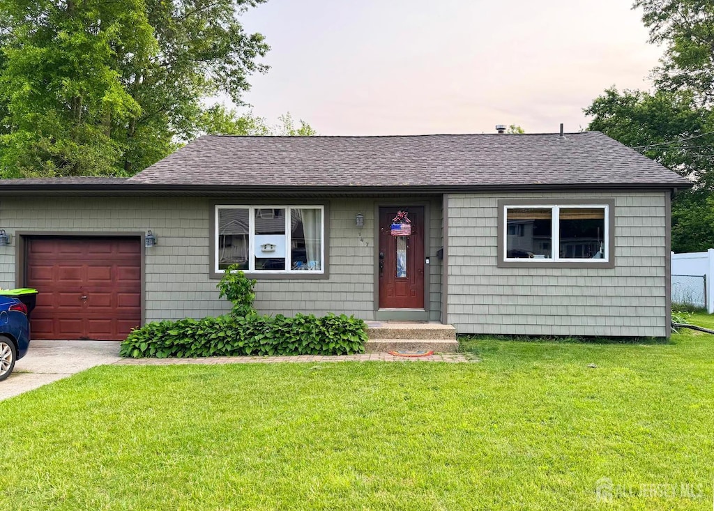 147 Cindy St, Old Bridge, NJ 08857 - ranch-style home featuring an attached garage, roof with shingles, a front lawn, and driveway
