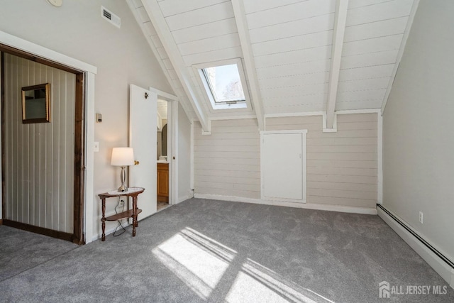 interior space with lofted ceiling with skylight, visible vents, carpet flooring, and a baseboard radiator