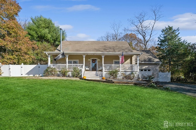 view of front of home with a gate, a porch, fence, a front yard, and a garage