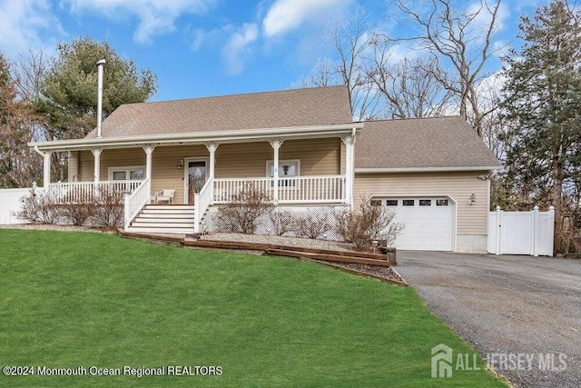 view of front facade featuring a front lawn, aphalt driveway, fence, covered porch, and a garage