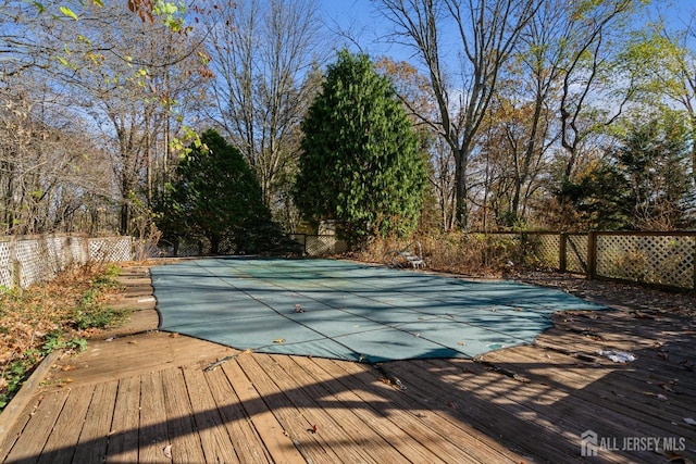 view of pool with a deck and fence