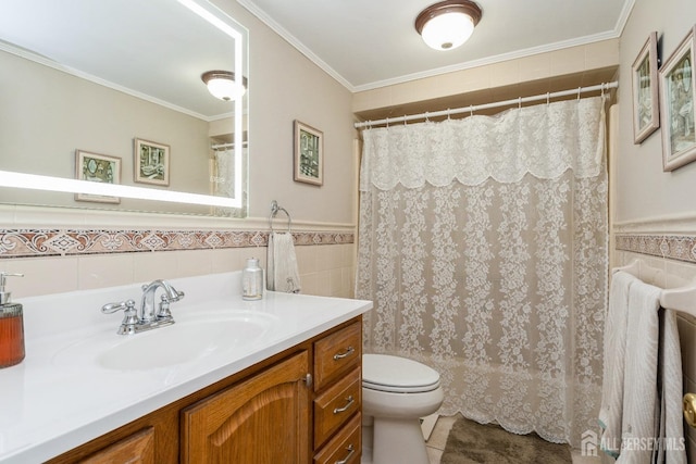 full bathroom featuring toilet, tile walls, ornamental molding, and vanity