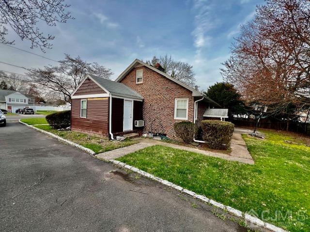 view of front of home with brick siding and a front yard