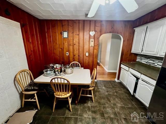 dining room with wooden walls