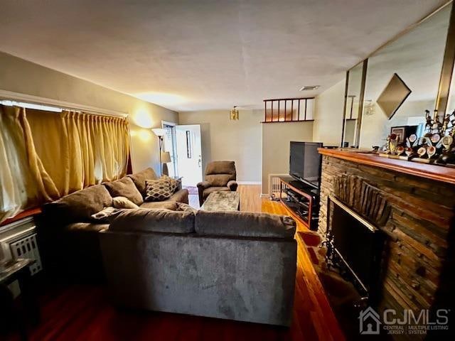 living room with a fireplace and dark hardwood / wood-style floors