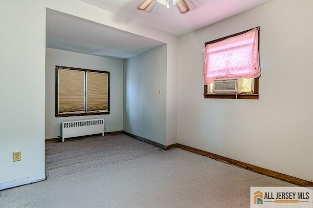 31 Lehigh Ave, Edison, NJ 08837 - empty room with radiator heating unit, cooling unit, a ceiling fan, and carpet flooring