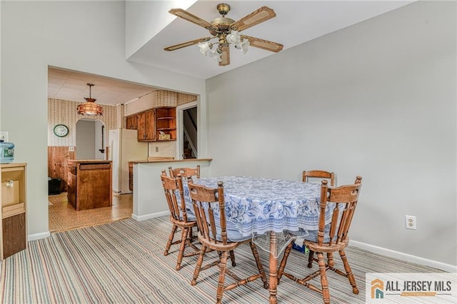31 Lehigh Ave, Edison, NJ 08837 - dining room with light colored carpet, a ceiling fan, wallpapered walls, and arched walkways
