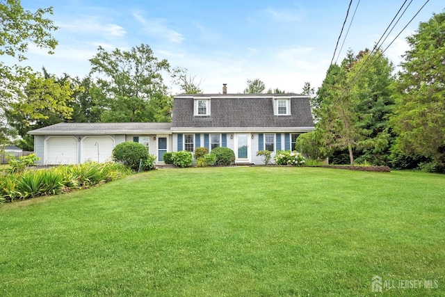 colonial inspired home featuring an attached garage, a chimney, a front lawn, and a gambrel roof