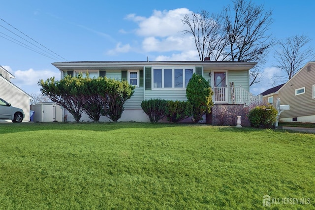 view of front of home with a storage shed and a front lawn