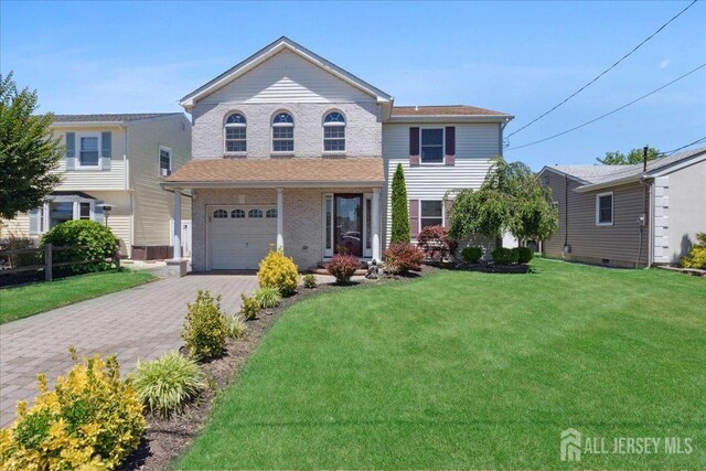 view of front of house with a garage and a front yard