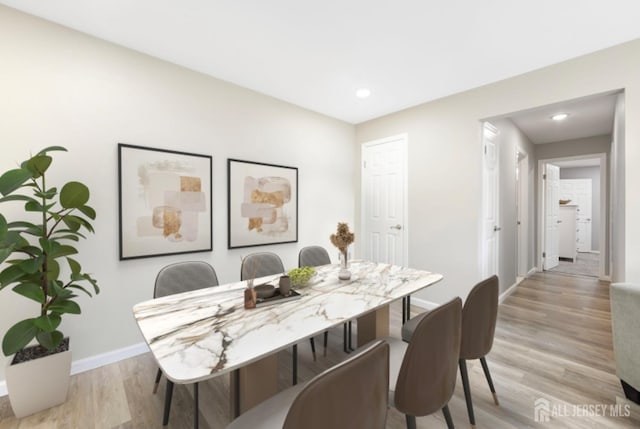 dining space with recessed lighting, baseboards, and light wood finished floors