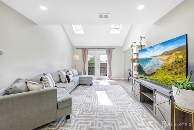 living room with visible vents, recessed lighting, light wood-style flooring, and lofted ceiling with skylight