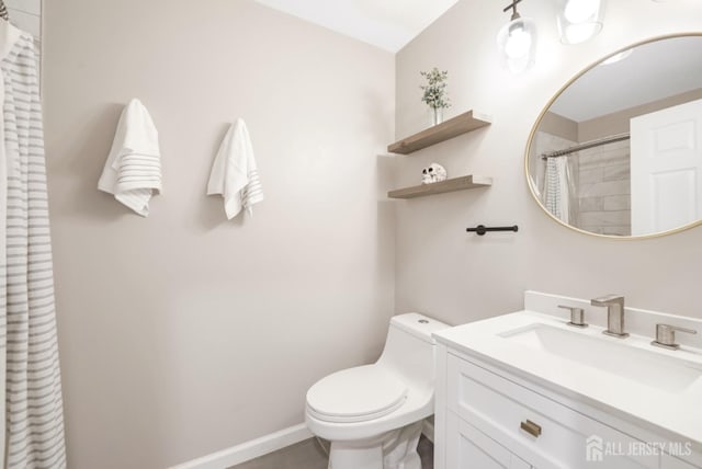 bathroom with vanity, baseboards, toilet, and curtained shower