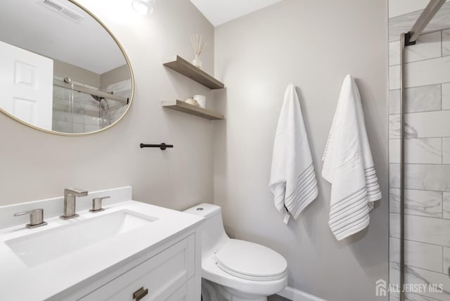 bathroom with an enclosed shower, toilet, visible vents, and vanity