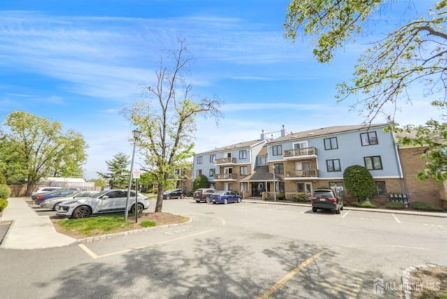 view of road with a residential view, sidewalks, and curbs