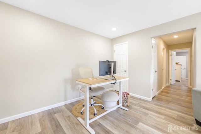 office area featuring baseboards, recessed lighting, and light wood finished floors